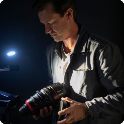 Andrew Wedhe holding a cinema lens